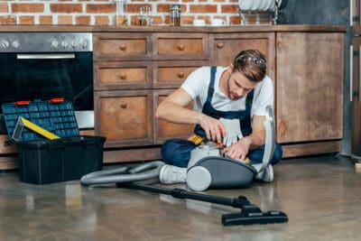 professional repairman fixing vacuum cleaner 2021 09 02 03 31 41 utc